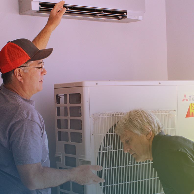 Man and woman setting up HVAC system